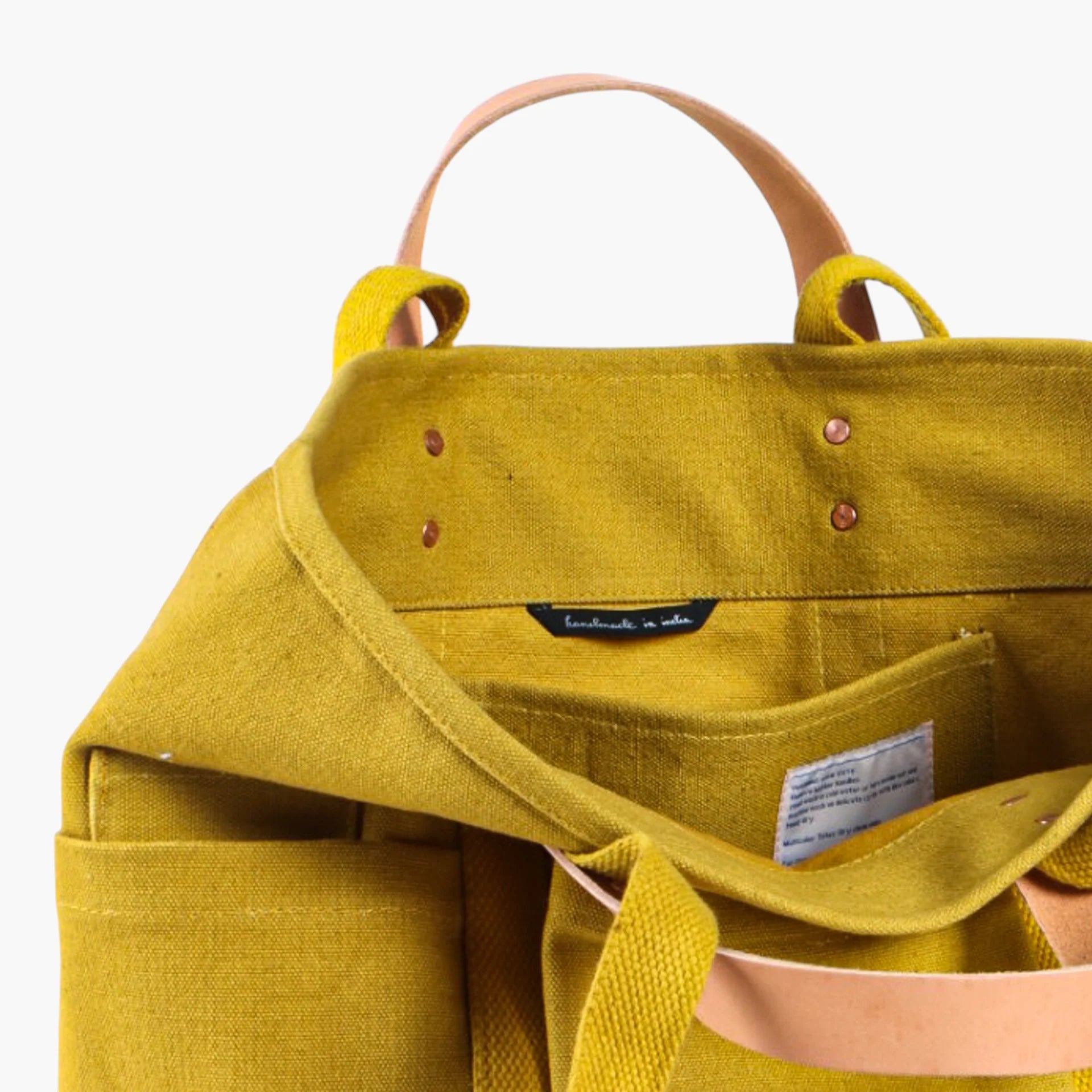 Tuck away your water bottle and keys in the front pockets, your paint brushes in the inside pocket. The Construction Tote is the same size as our Small East West Tote but with more hiding places.

• Converts from handheld to shoulder with detachable leather handles
• Once the handles are removed, the tote is washable
• All seams are double stitched and bound with cotton on the inside
• Two interior pockets and three exterior pockets
• Leather handles will patina over time with exposure to the sun and the oi
