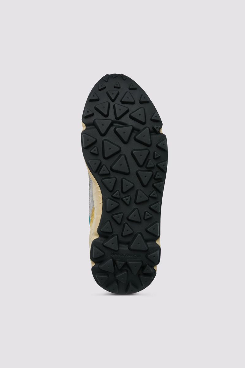 Sneakers with a dynamic character, perfect for urban or outdoor use. The upper is made of suede and fabric, ensuring a contemporary design. Distinctive details such as flower-shaped eyelets and technical strings make the footwear unique. Internally, the leather and fabric lining guarantees comfort while the cork inner insole ensures well-being. Lightweight sole for a comfortable walk.