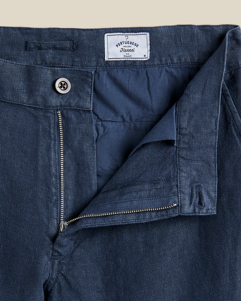 Portuguese Flannel's trousers are made from linen that's milled in Guimarães; the brand's home since 1927. Dyed navy, they're cut in a neat, straight-leg shape and have a little coin pocket by the waistband. Lower Impact Materials. This product is made using at least 50% lower-impact materials or ingredients.