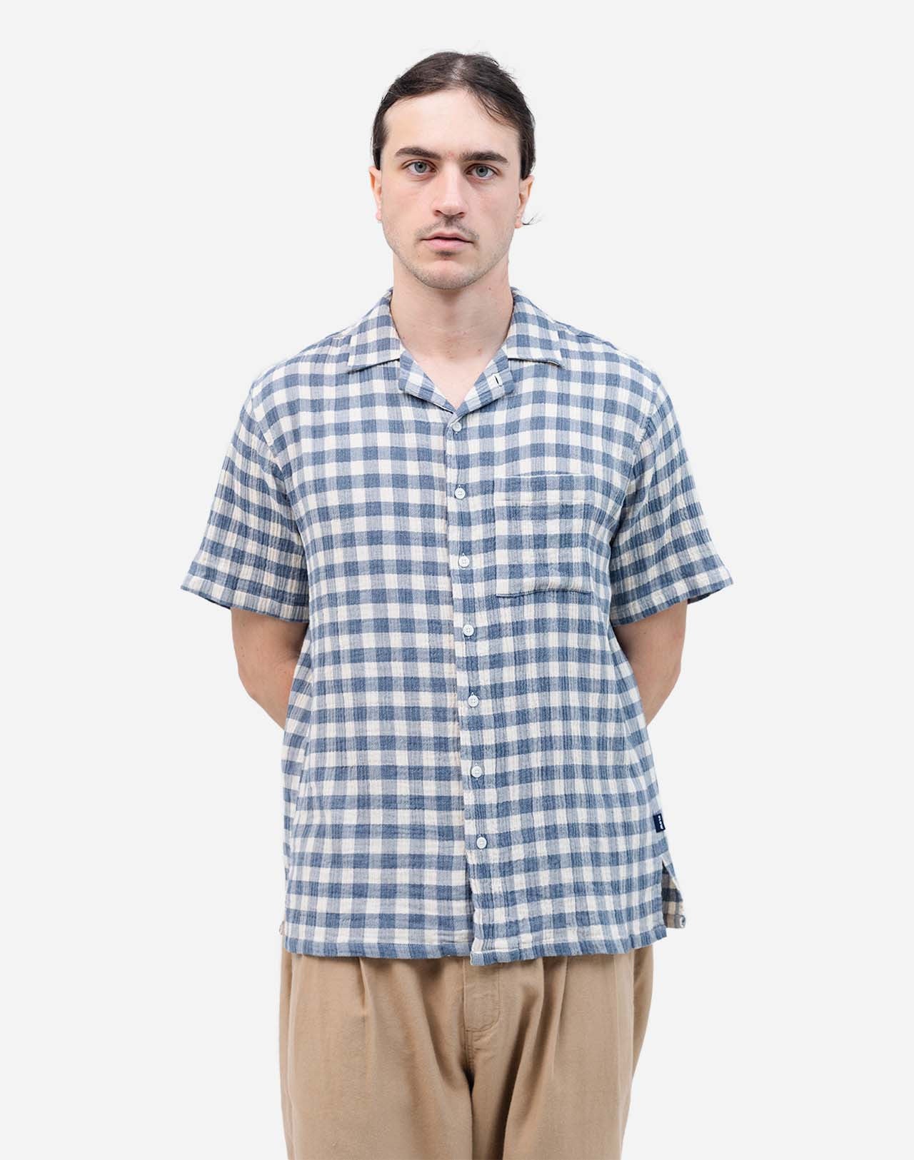 With its checkered pattern, this Hawaiian-cut short-sleeved shirt evokes a sunny summer day. Its fluid and relaxed silhouette makes it an easy piece for daily wear. Crafted from 100% cotton gauze (142g) and featuring corozo buttons, the Aloha Piknik shirt offers a breathable fabric that is soft to the touch. Its chest pocket completes a piece that is easy to style.