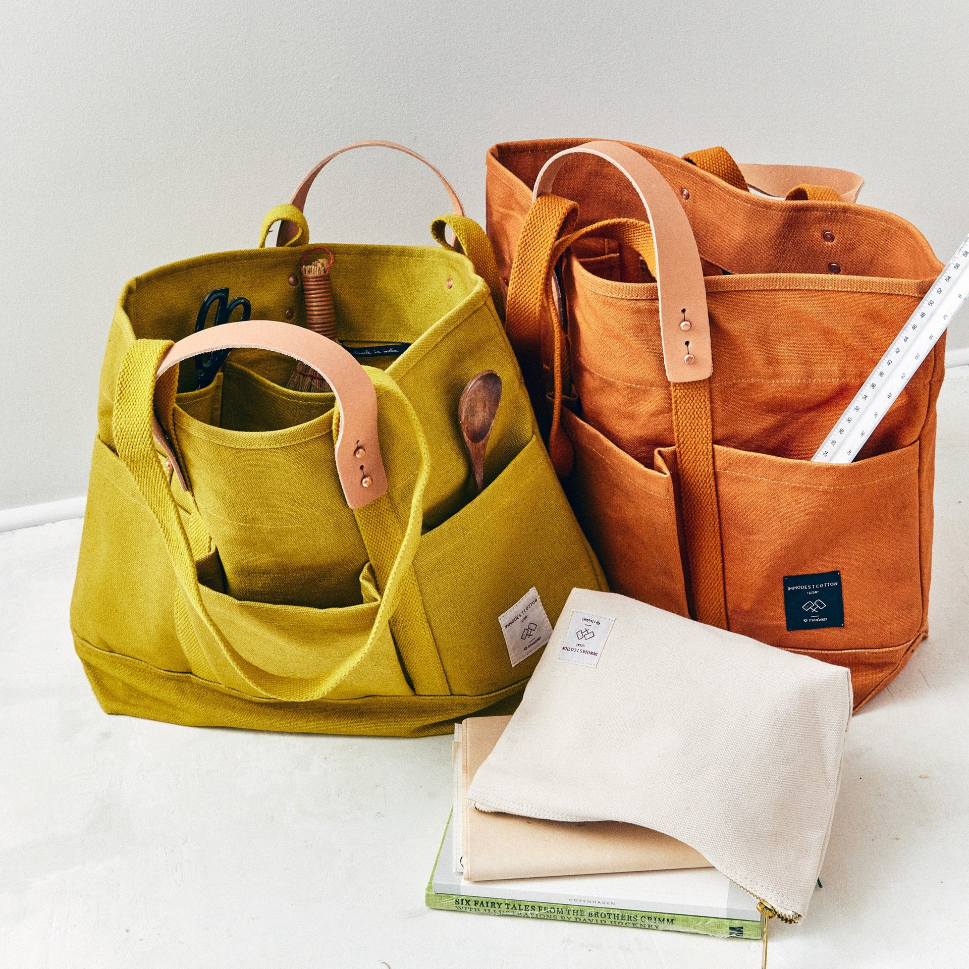 Tuck away your water bottle and keys in the front pockets, your paint brushes in the inside pocket. The Construction Tote is the same size as our Small East West Tote but with more hiding places.

• Converts from handheld to shoulder with detachable leather handles
• Once the handles are removed, the tote is washable
• All seams are double stitched and bound with cotton on the inside
• Two interior pockets and three exterior pockets
• Leather handles will patina over time with exposure to the sun and the oi